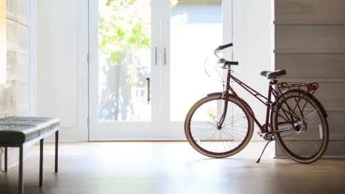 Free cruiser bike provided by the Kimpton Hotel Monaco in front of a glass door